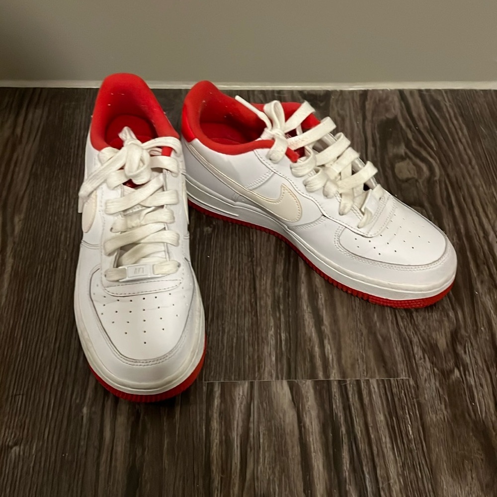 white and red nike air force 1’s